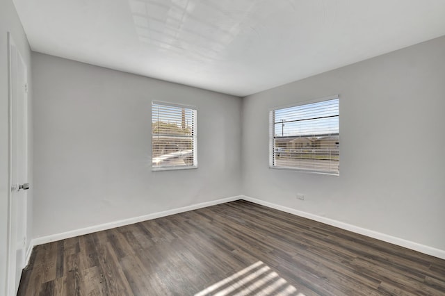 unfurnished room featuring dark wood-type flooring