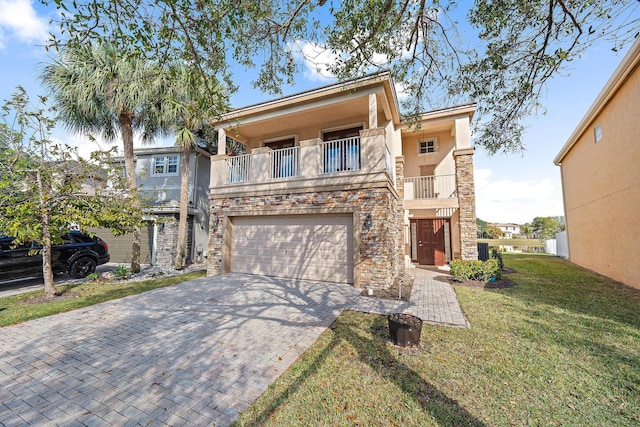 view of front of property featuring a front yard, a garage, and a balcony