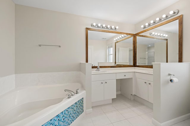 bathroom with vanity, tile patterned floors, and tiled tub