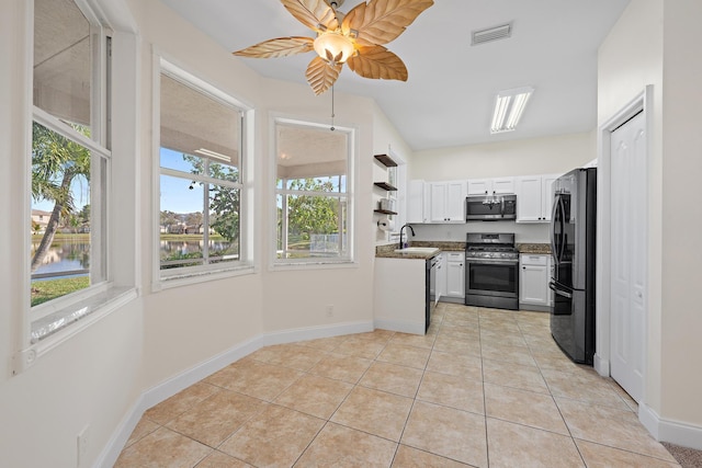 kitchen featuring white cabinets, stainless steel appliances, sink, ceiling fan, and light tile patterned floors