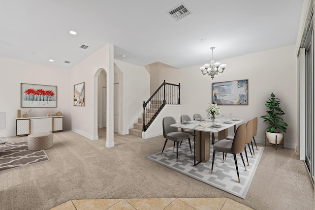 dining space featuring light tile patterned flooring and an inviting chandelier