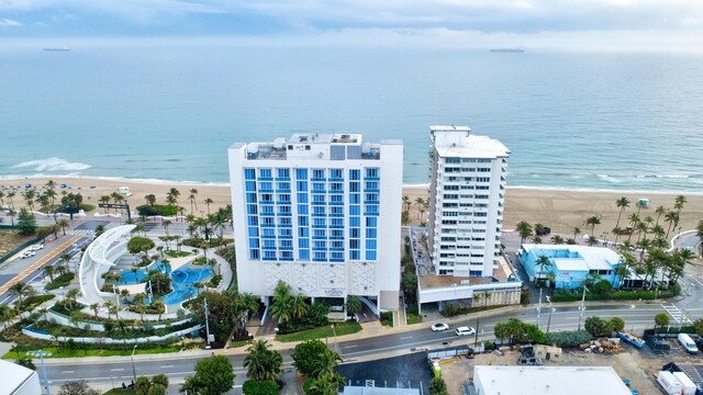 bird's eye view with a water view and a beach view