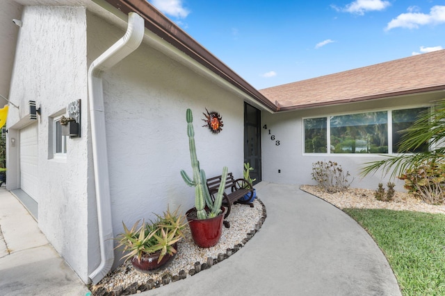 view of exterior entry with a garage