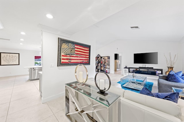 living room featuring vaulted ceiling and light tile patterned floors