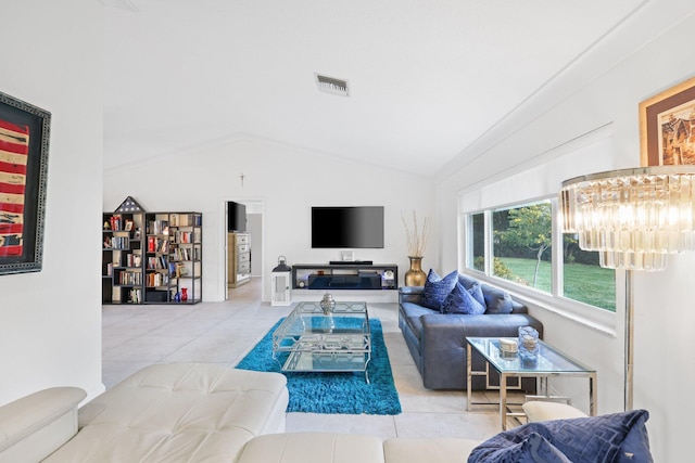 tiled living room featuring a chandelier and lofted ceiling