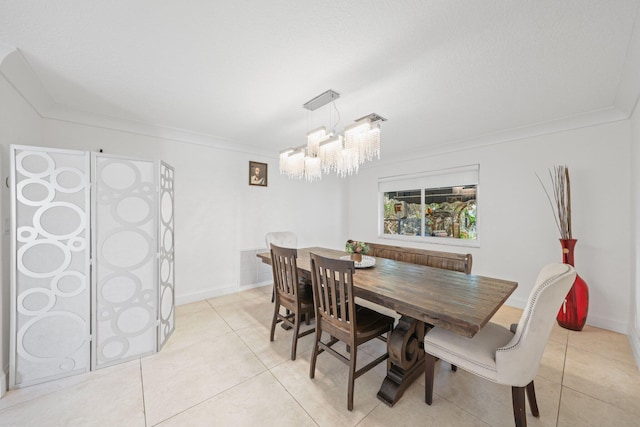 dining area with an inviting chandelier, light tile patterned floors, and ornamental molding