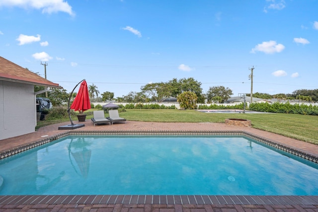 view of pool with a yard and a patio