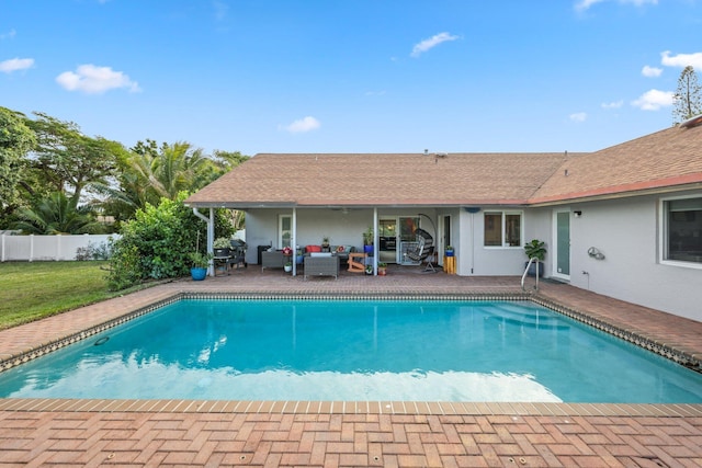 view of pool with an outdoor living space and a patio area