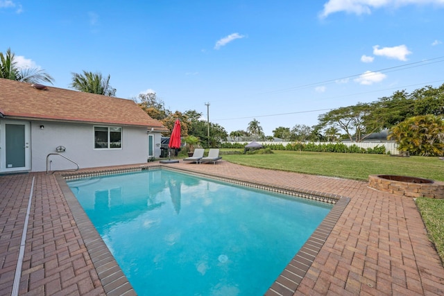 view of swimming pool with a lawn and a patio