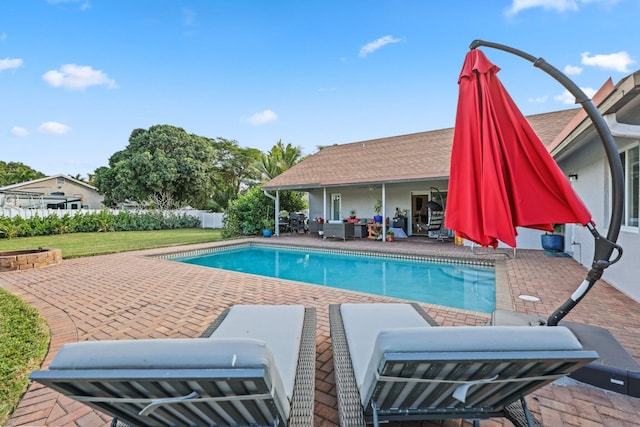 view of pool with an outdoor hangout area, a patio area, and a lawn