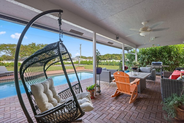 view of patio with ceiling fan, an outdoor living space, and a grill