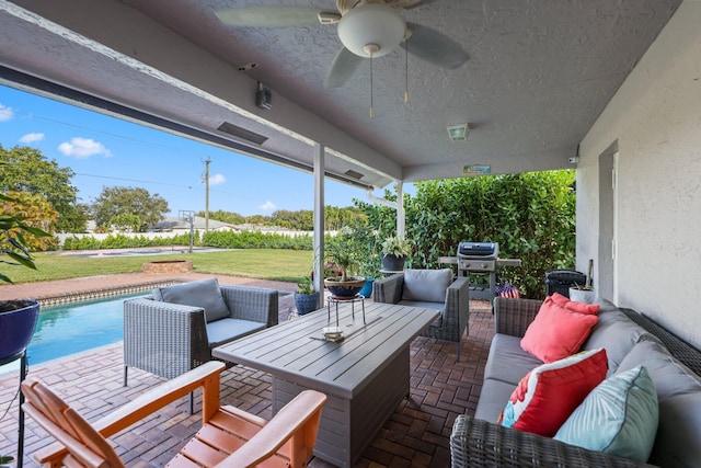 deck with ceiling fan, an outdoor hangout area, a yard, and a patio