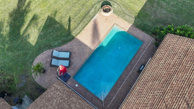 view of pool featuring a lawn