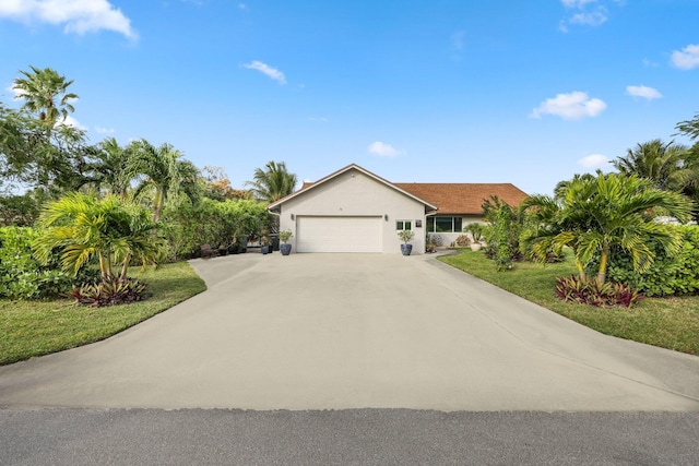 ranch-style house with a front yard and a garage