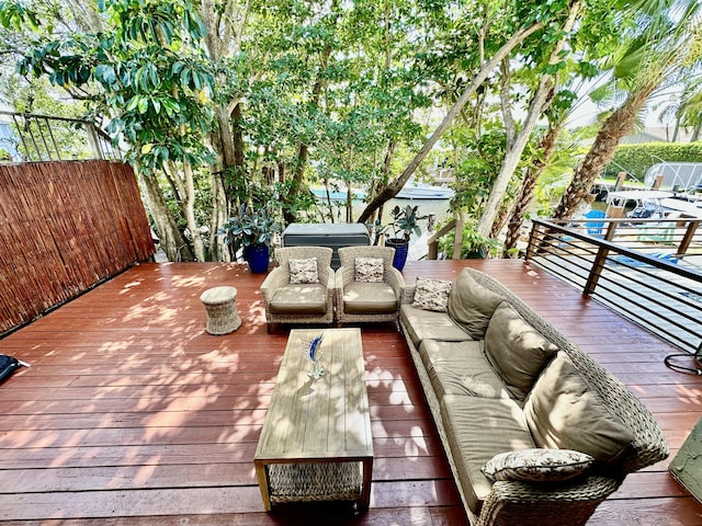 wooden terrace featuring area for grilling and an outdoor hangout area