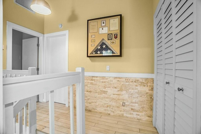 corridor with hardwood / wood-style flooring