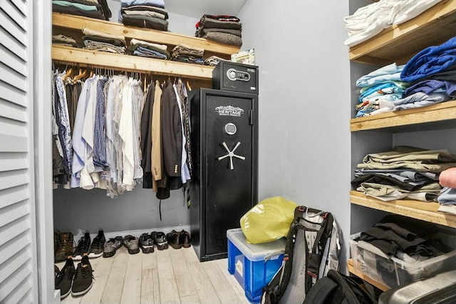 walk in closet with light hardwood / wood-style floors