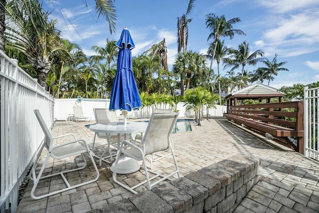 view of patio / terrace featuring a fenced in pool and a gazebo