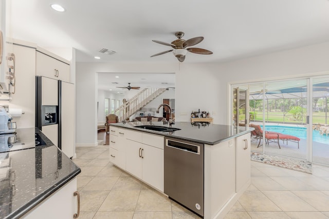 kitchen featuring refrigerator with ice dispenser, dishwasher, white cabinetry, and sink