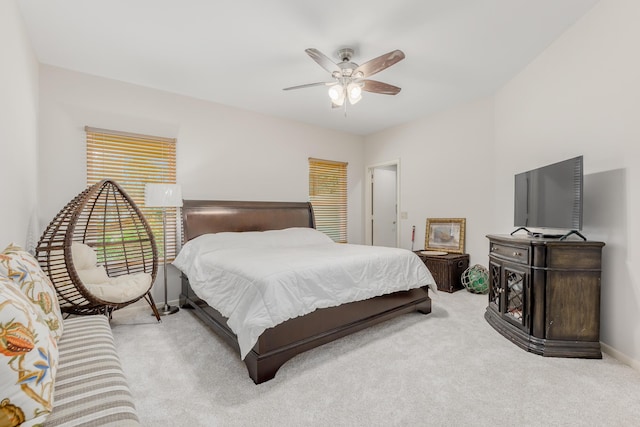 bedroom with ceiling fan and light carpet