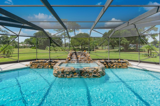 view of pool featuring pool water feature, glass enclosure, and a lawn