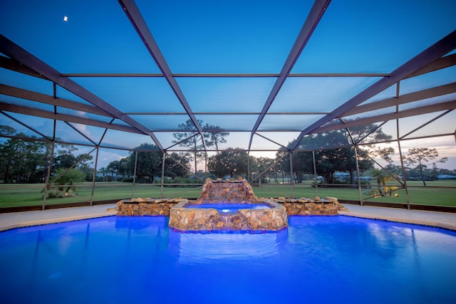 pool at dusk featuring glass enclosure and pool water feature