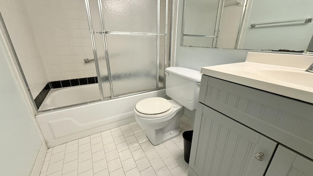 full bathroom featuring tile patterned floors, shower / bath combination with glass door, vanity, and toilet