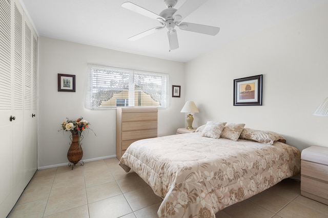 bedroom with a closet, ceiling fan, and light tile patterned floors