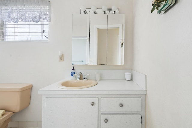 bathroom featuring vanity and toilet