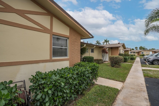 view of side of home featuring a yard