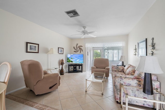 living room with ceiling fan and light tile patterned flooring