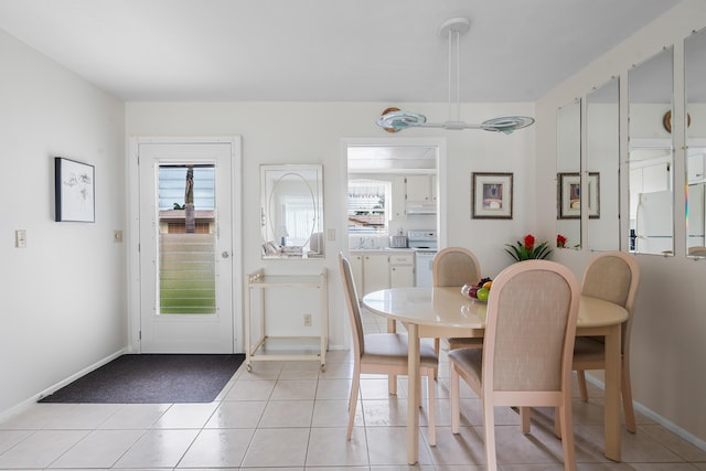 dining space featuring light tile patterned floors and plenty of natural light