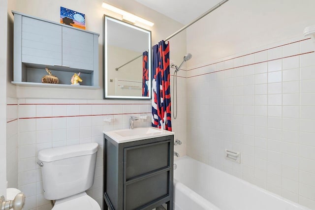 full bathroom with vanity, toilet, tile walls, and shower / tub combo with curtain