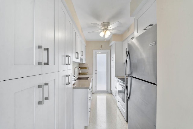 kitchen featuring white cabinetry, sink, ceiling fan, and appliances with stainless steel finishes