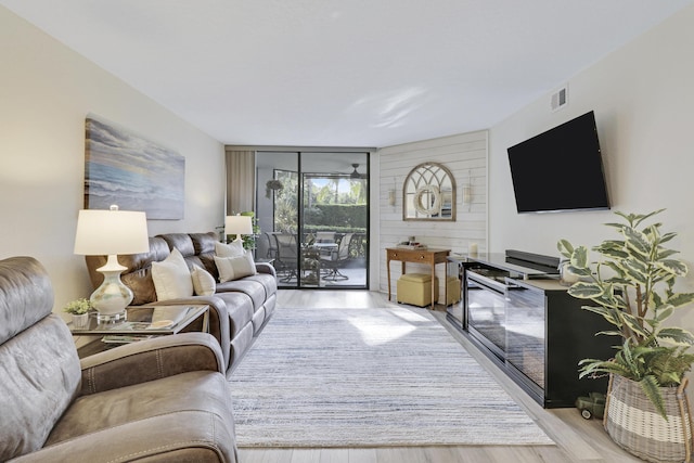 living room with expansive windows and light wood-type flooring