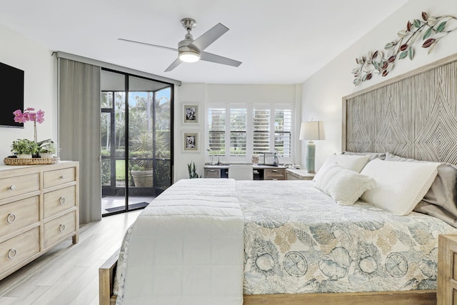 bedroom featuring ceiling fan, access to exterior, a wall of windows, and light hardwood / wood-style flooring