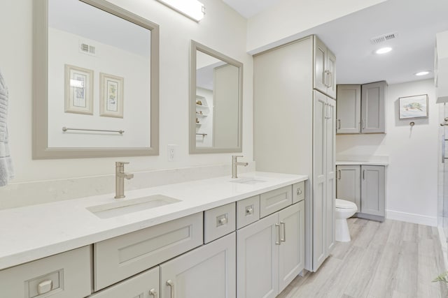 bathroom featuring hardwood / wood-style floors, vanity, and toilet