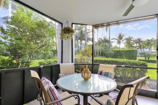 sunroom / solarium featuring ceiling fan