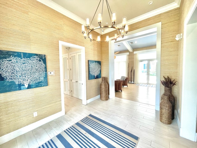 corridor featuring crown molding, french doors, hardwood / wood-style floors, and a notable chandelier