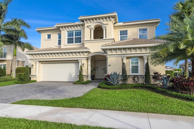 mediterranean / spanish-style house featuring a front lawn and a garage