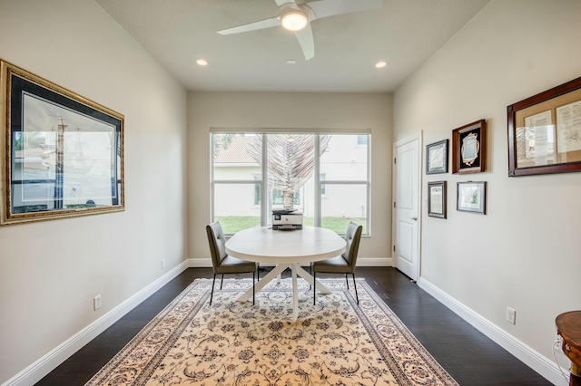 dining room with ceiling fan and dark wood-type flooring