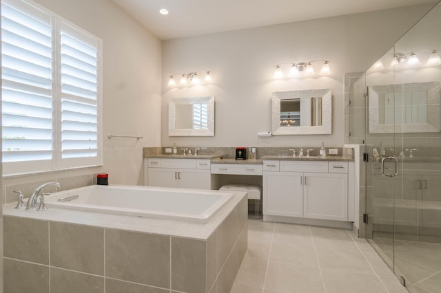 bathroom with vanity, tile patterned flooring, and shower with separate bathtub