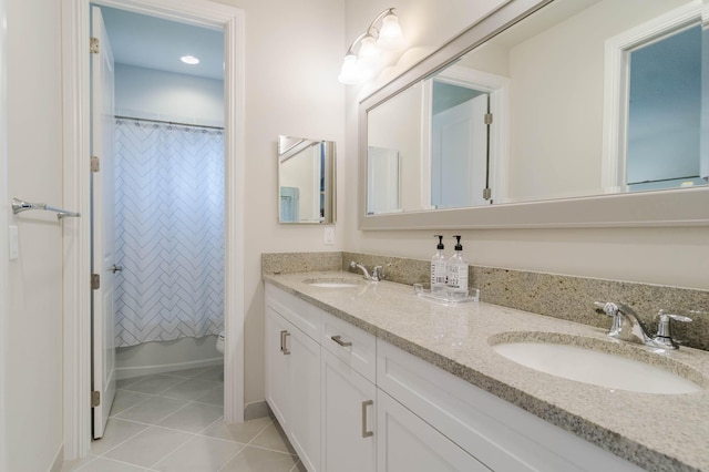 bathroom with toilet, tile patterned floors, and vanity