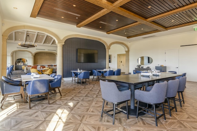 dining room featuring beam ceiling, a towering ceiling, coffered ceiling, ornamental molding, and wooden ceiling