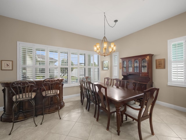 tiled dining space featuring an inviting chandelier and a wealth of natural light