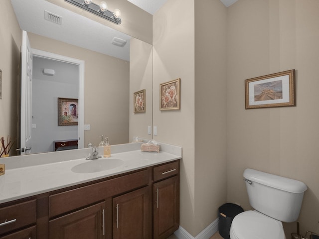 bathroom featuring toilet and vanity