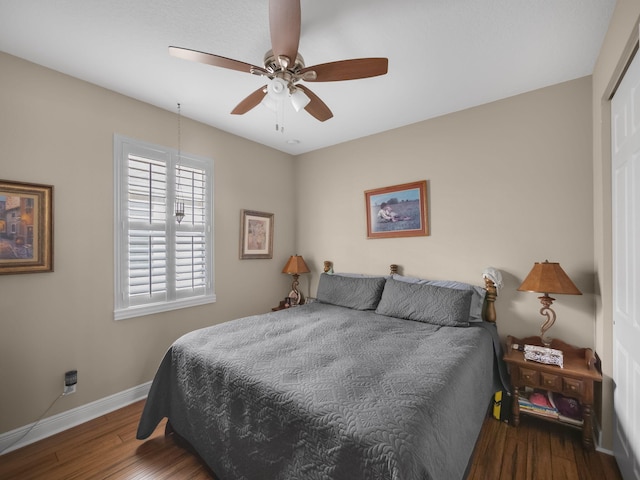 bedroom with a closet, ceiling fan, and dark wood-type flooring