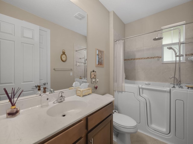 bathroom with toilet, tile patterned floors, and vanity