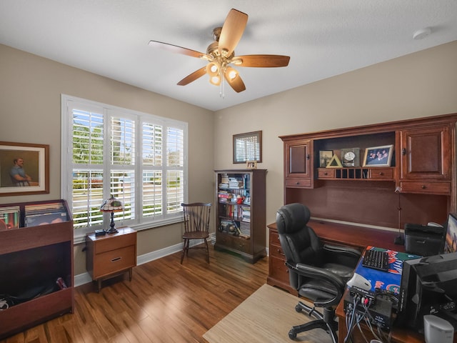 home office with ceiling fan and hardwood / wood-style floors