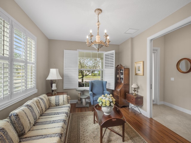 living room featuring light hardwood / wood-style floors and a notable chandelier